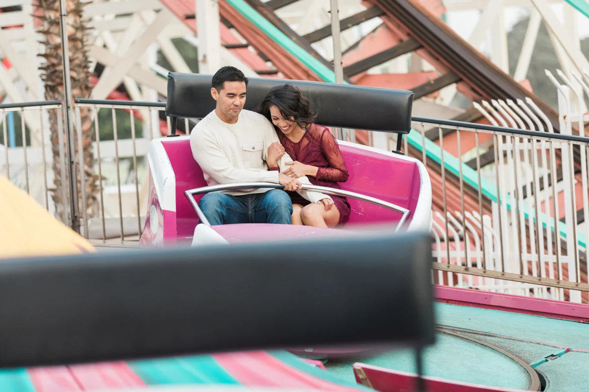 belmont park engagement session san diego couple on twirling ride