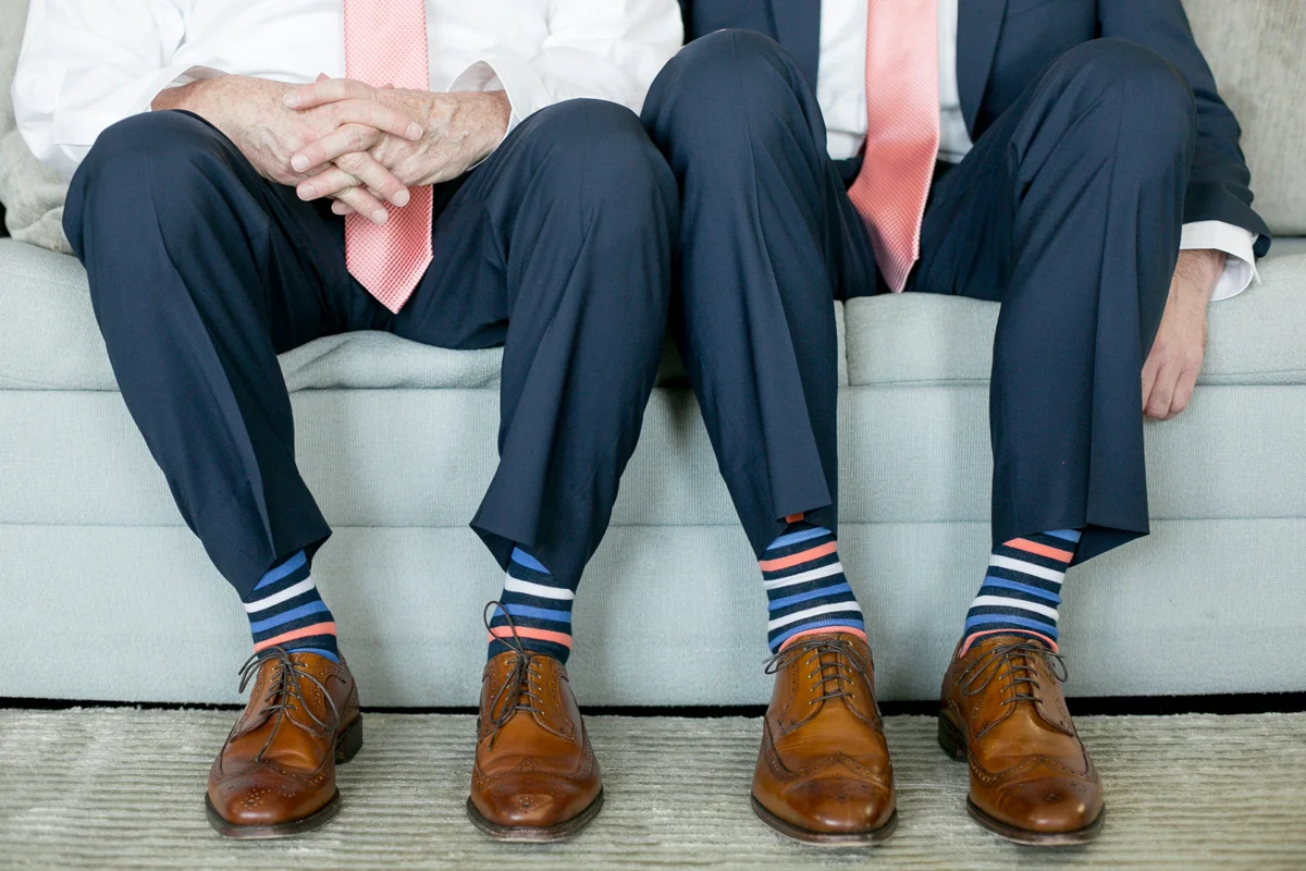 elegant, heartfelt alexandria, va wedding grooms on couch in matching outfits