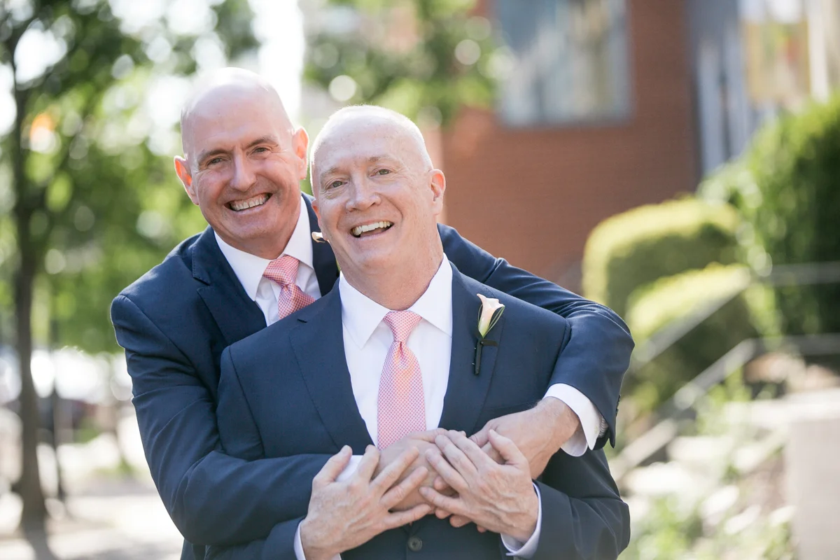 elegant, heartfelt alexandria, va wedding grooms smiling on sidewalk