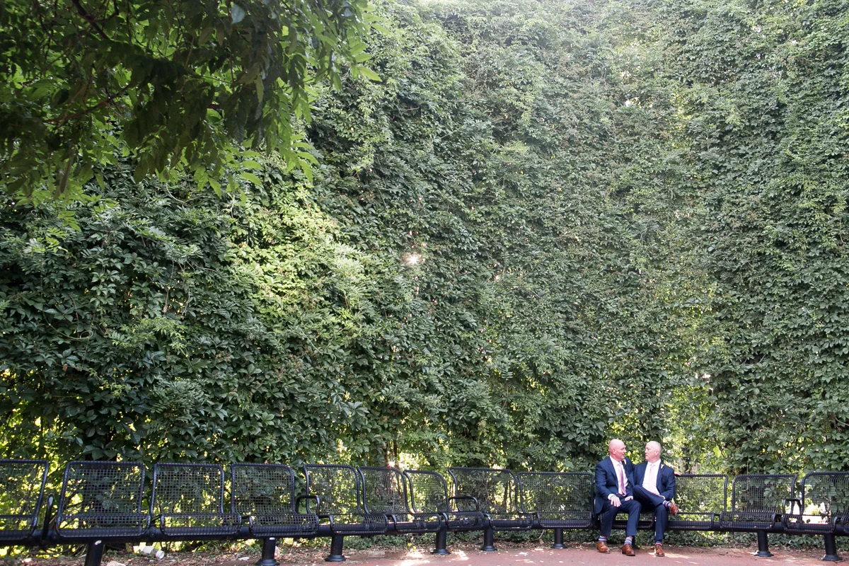 elegant, heartfelt alexandria, va wedding grooms on terrace chairs surrounded by trees