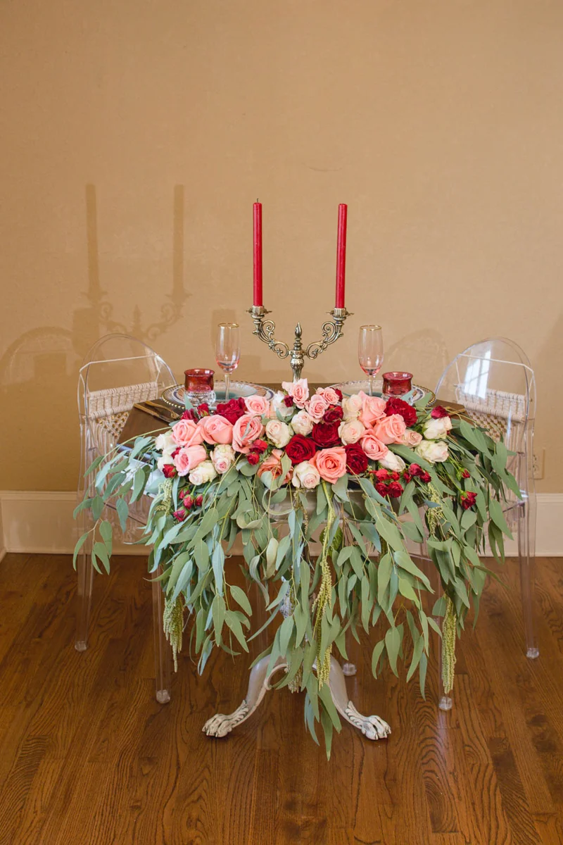 B ohemian Styled Shoot table with candelabra and rose arrangement on front