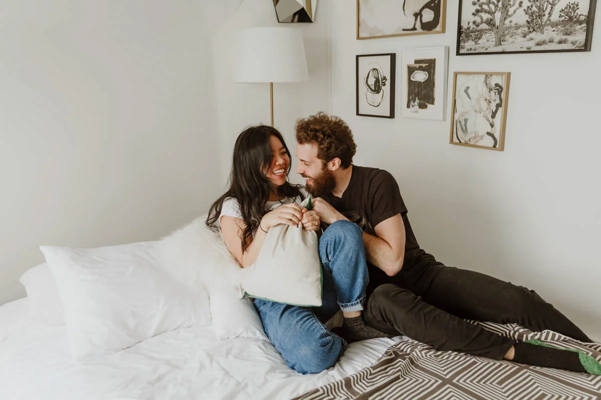 joshua tree california engagement session couple on bed laughing