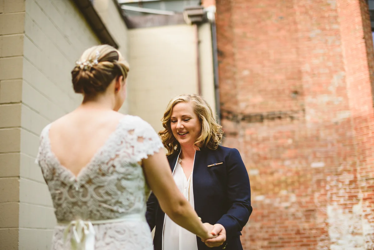 BALTIMORE WEDDING AT MOUNT WASHINGTON MILL DYE HOUSE FIRST LOOK COUPLE HOLDING HANDS