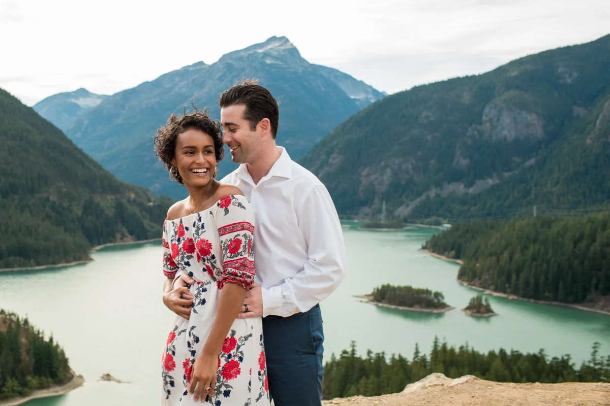 Diablo lake engagement session candid overlooking lake and mountains