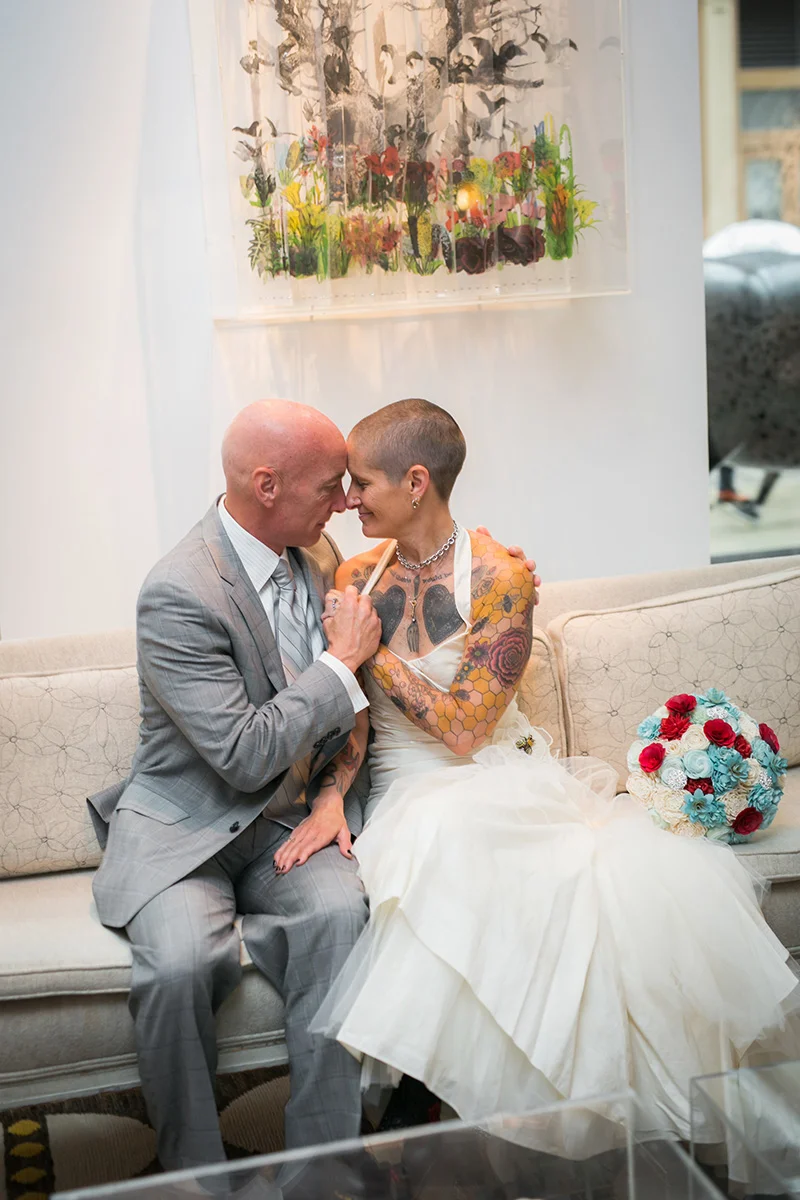 tattooed feminist elopement nyc frank and inger on sofa sitting close together