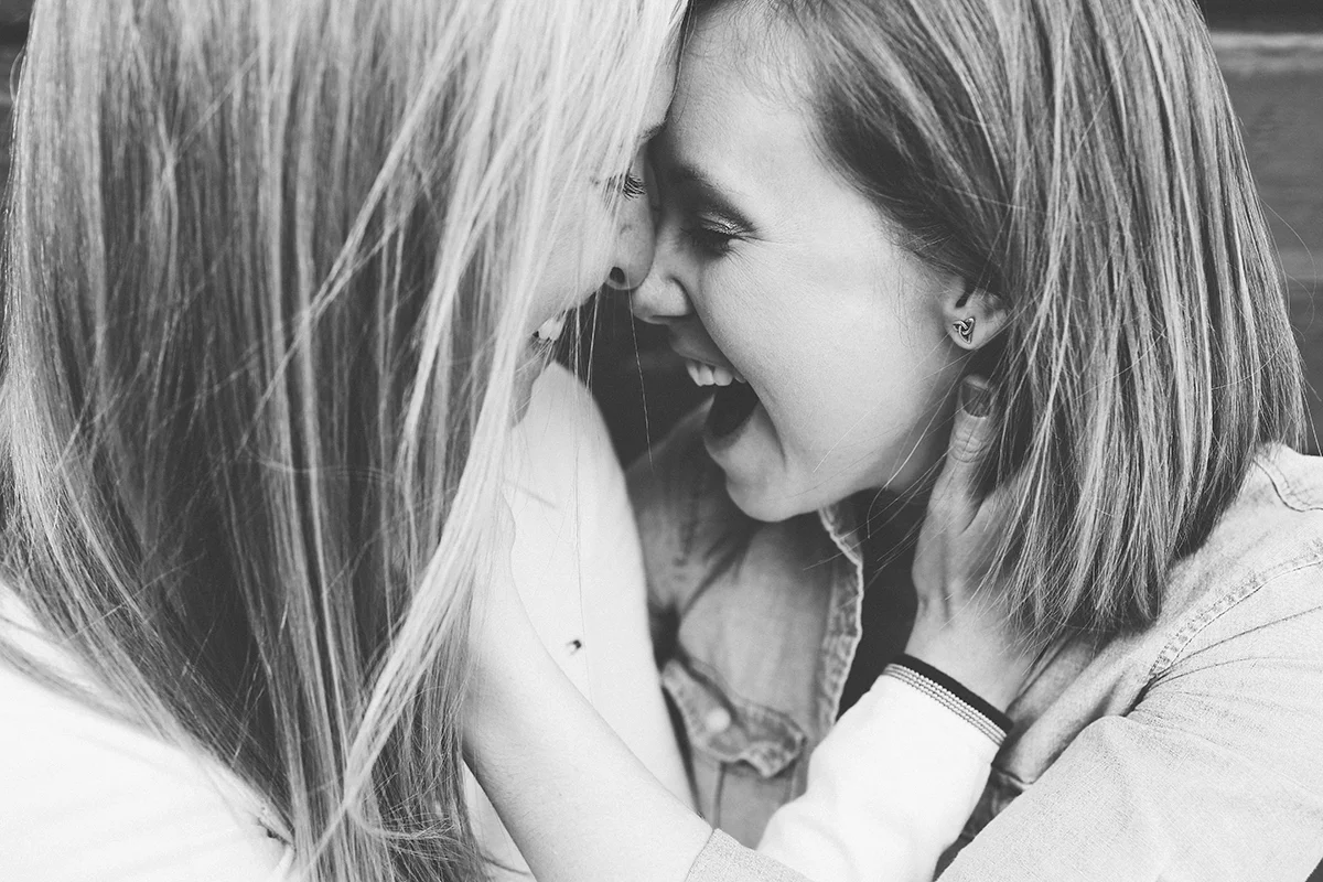 Mt. airy north carolina natural engagement ashley and ruthie laughing with faces close