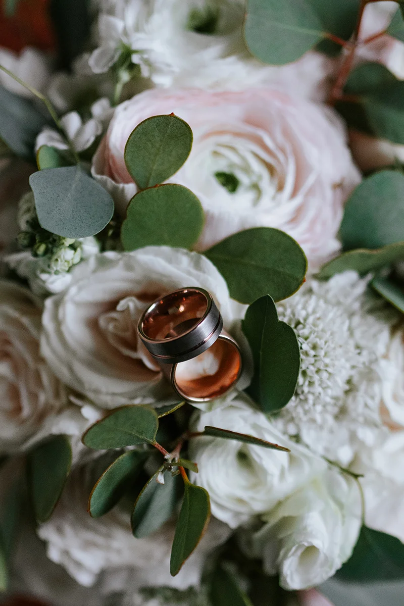 baltimore photo shoot wedding bands resting on bouquet