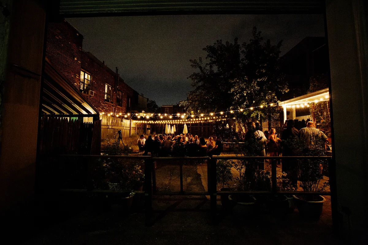 brooklyn bar wedding reception on patio lit with string lights