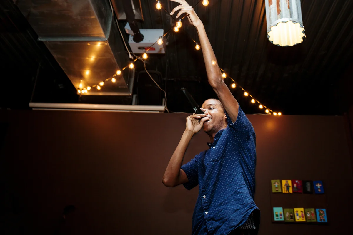 brooklyn bar wedding guest raising glass while speaking in microphone