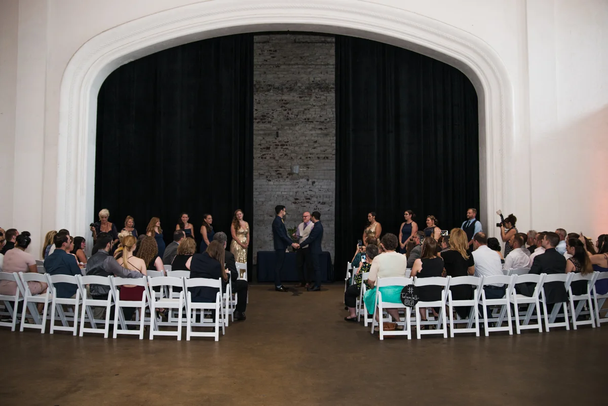 rialto theatre wedding ceremony in front of theatre curtains