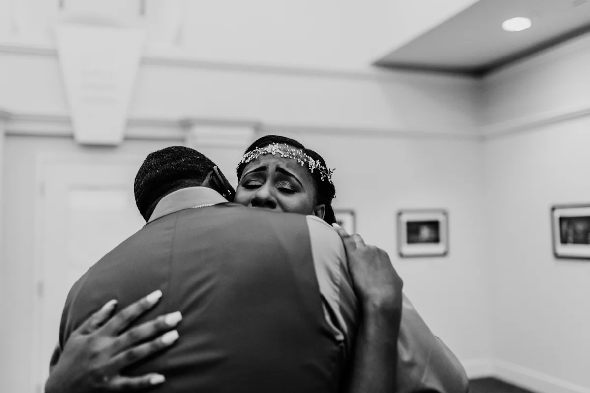 art-inspired levine museum wedding first look hug