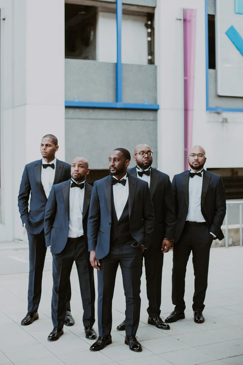 art-inspired levine museum wedding travis with groomsmen outside museum