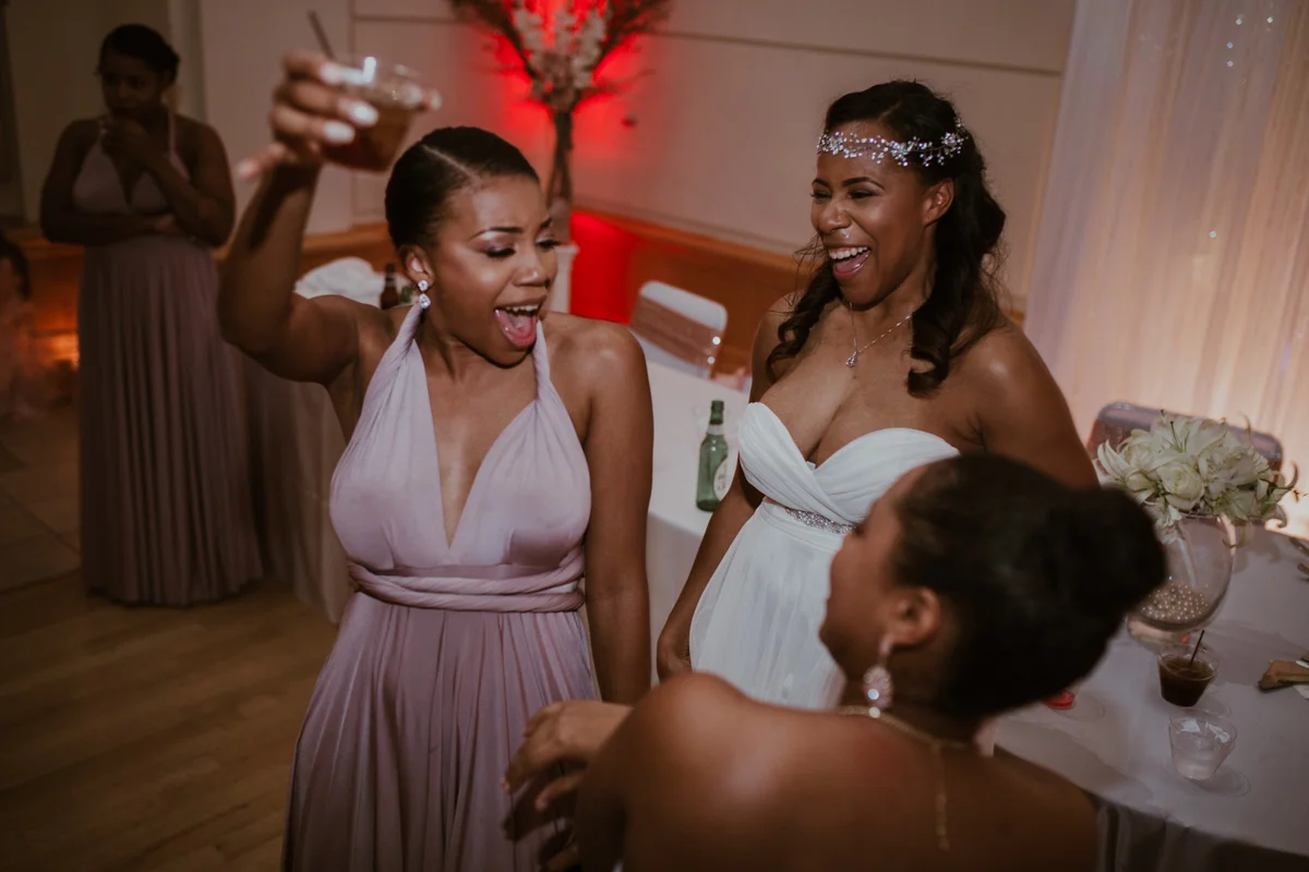 art-inspired levine museum wedding shavonne with bridesmaids, one holding up drink
