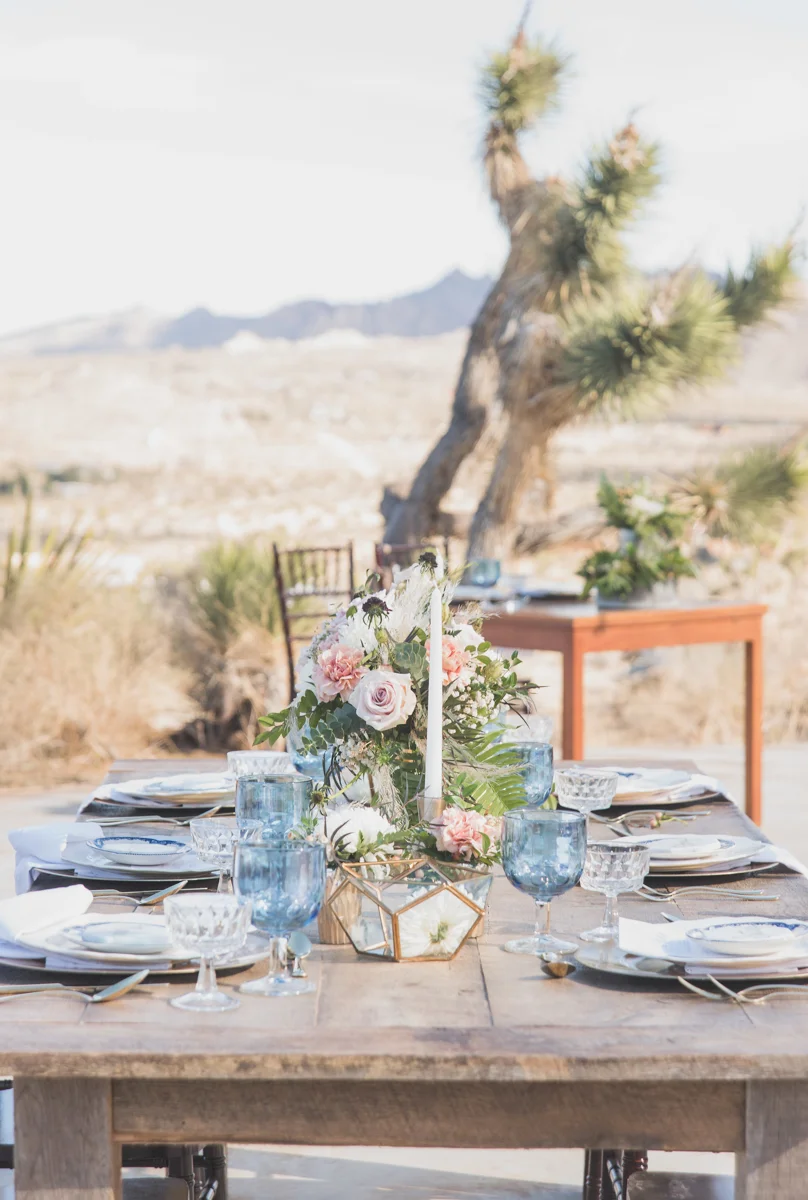multi-cultural desert elopement table settings with joshua tree and desert in background