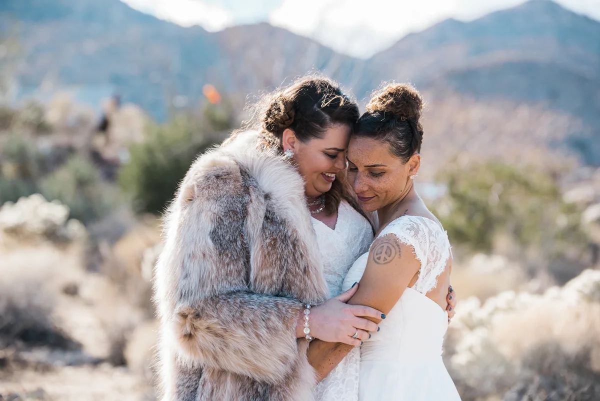 multi-cultural desert elopement embrace candid