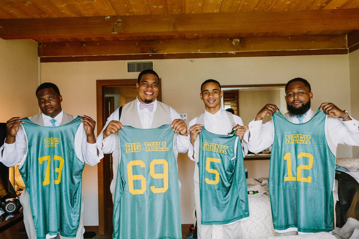 San Diego Tropical-Inspired Wedding william and groomsmen holding up custom jerseys