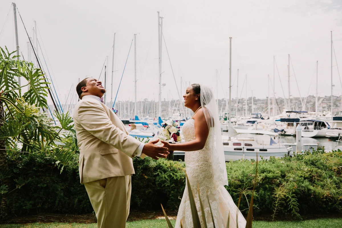 San Diego Tropical-Inspired Wedding first look laughing candid of william and janelle