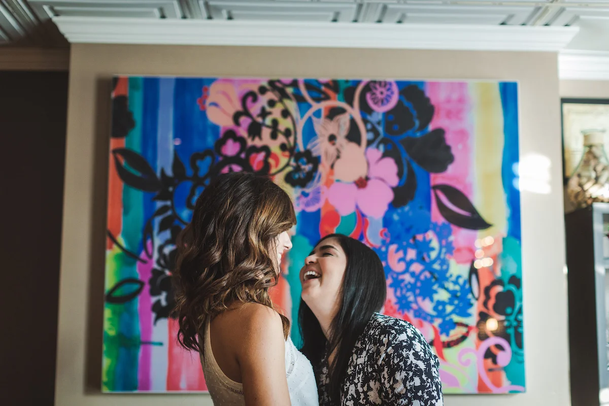 Wine Bar Engagement Virginia couple laughing in front of colorful mural