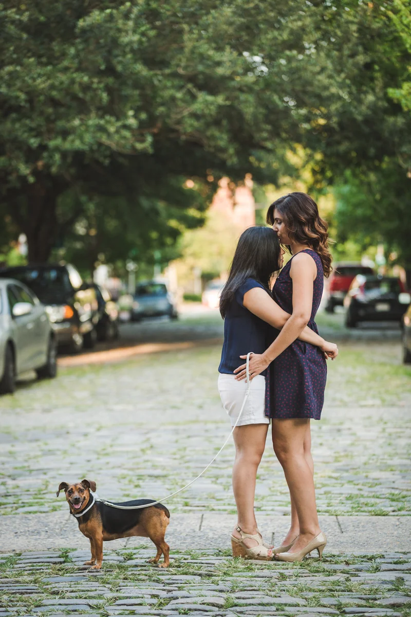  Wine Bar Engagement Virginia kiss on forehead on cobblestone street with their dog olga