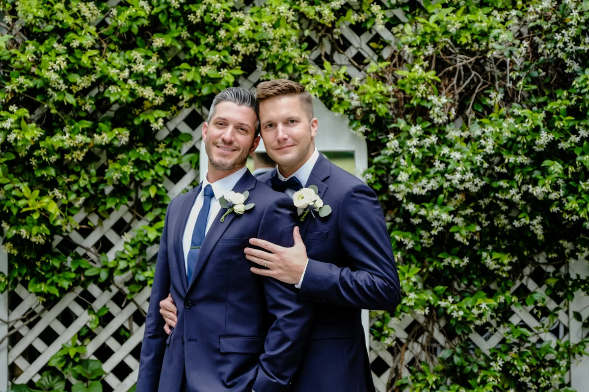 Classic southern style wedding savannah georgia ben and peter embrace in garden