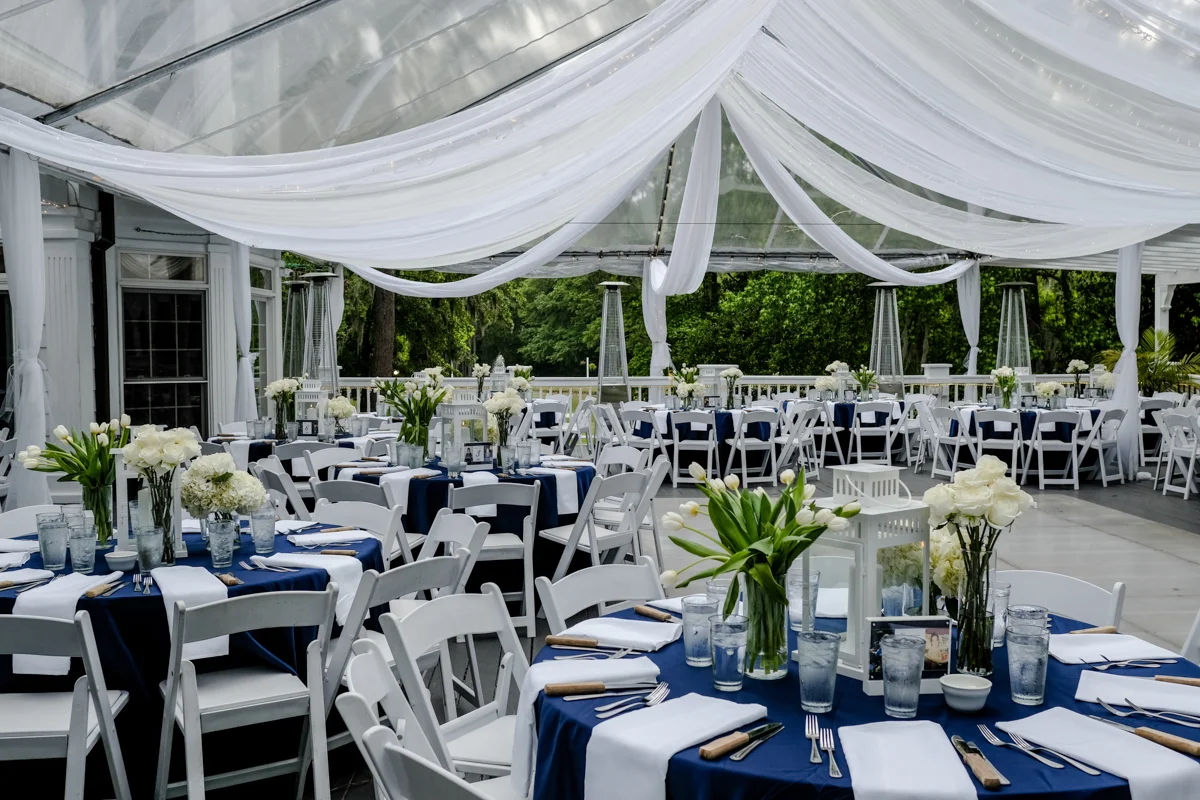 Classic southern style wedding savannah georgia outdoor reception area; empty tables with lantern and rose centerpieces
