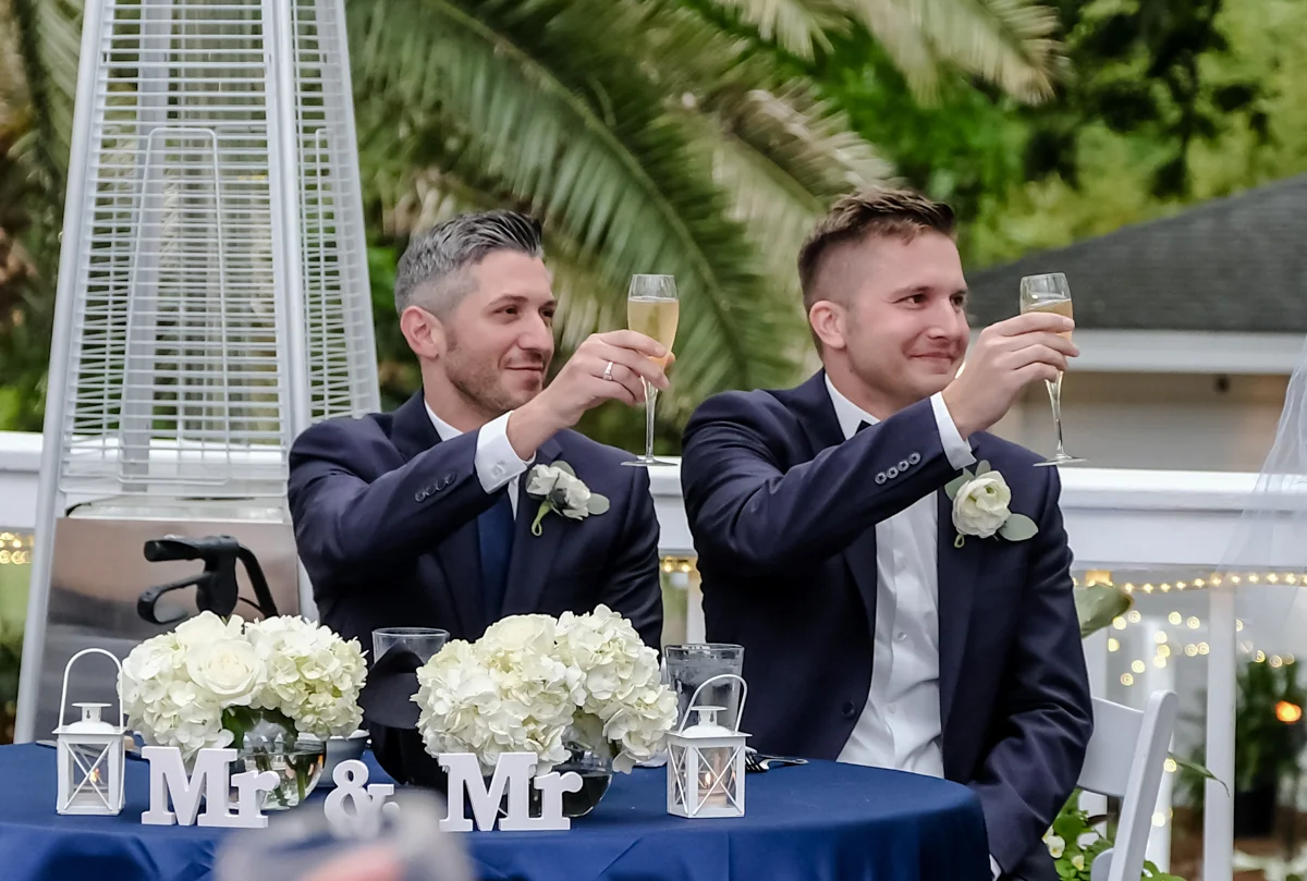 Classic southern style wedding savannah georgia grooms at table raising champagne glasses