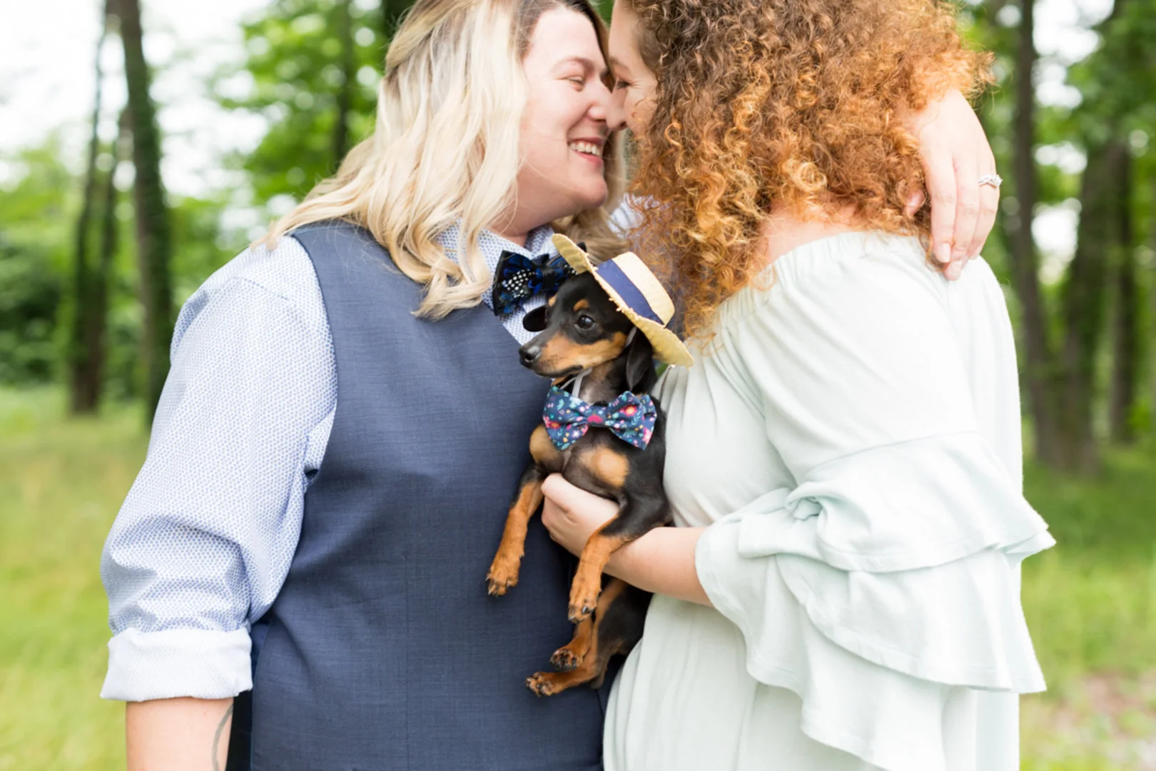 samantha and english about to kiss holding dog with bowtie and hat newlywed portraits columbia south carolina jessica hunt photography
