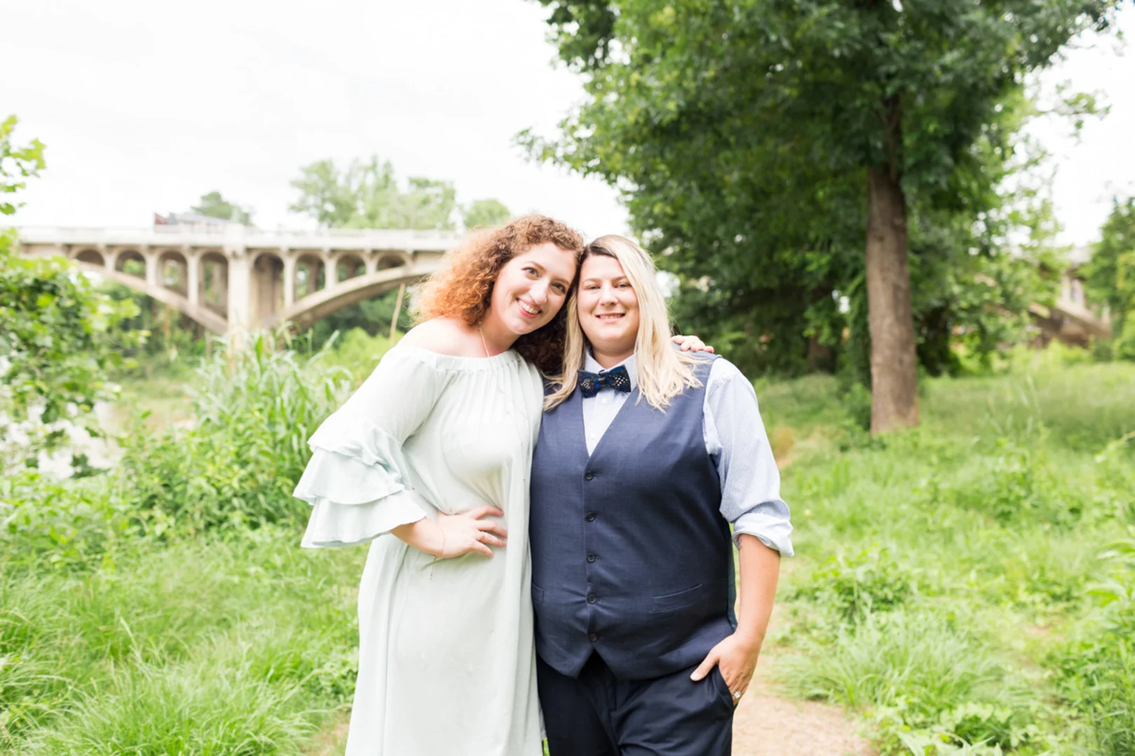 two brides LGBTQ newlywed portraits in field by bridge columbia south carolina jessica hunt photography