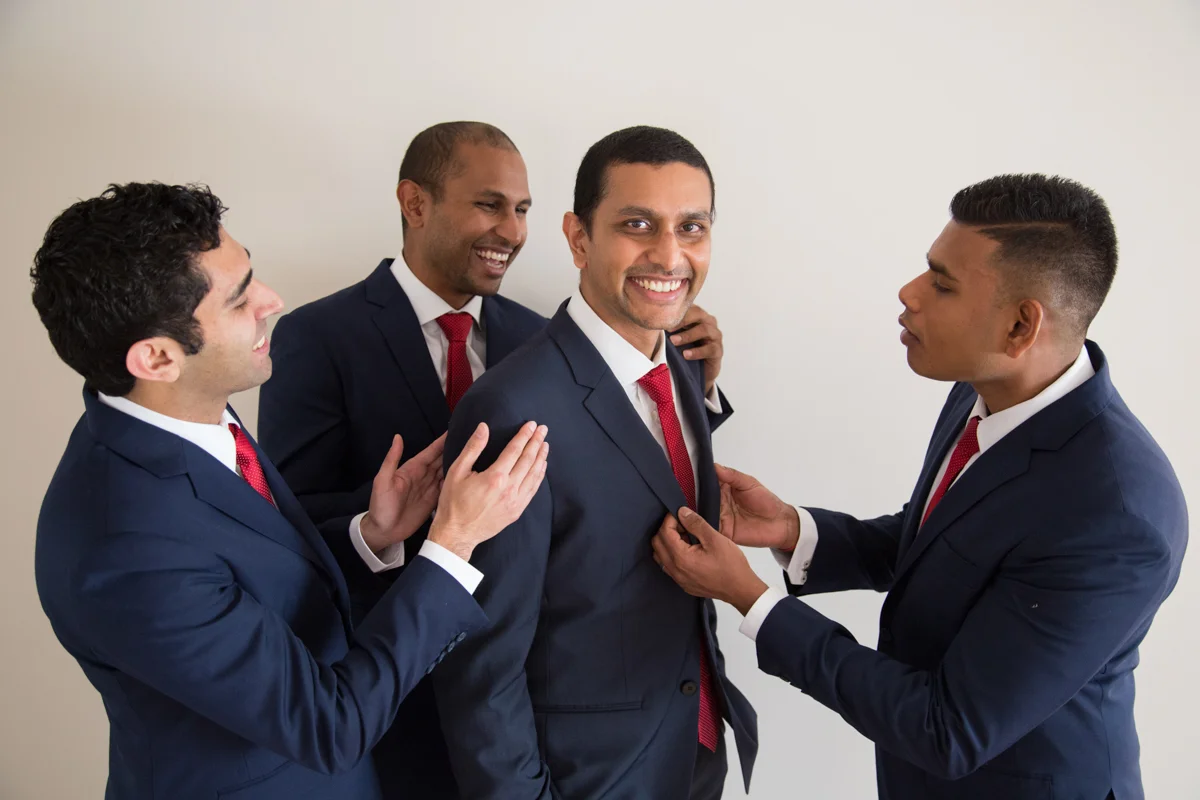 sri lankan wedding in sydney australia groom getting help with jacket from groomsmen