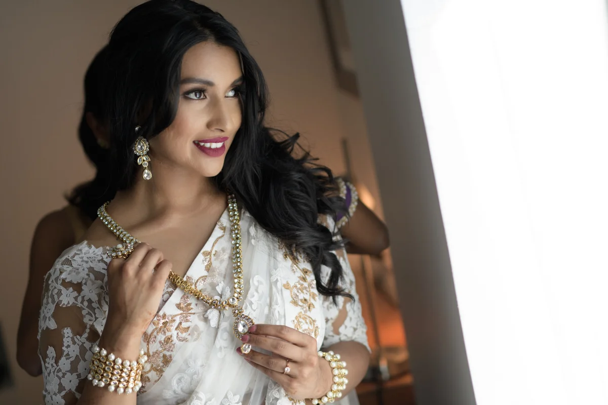 sri lankan wedding in sydney australia bride getting necklace fastened by bridesmaid