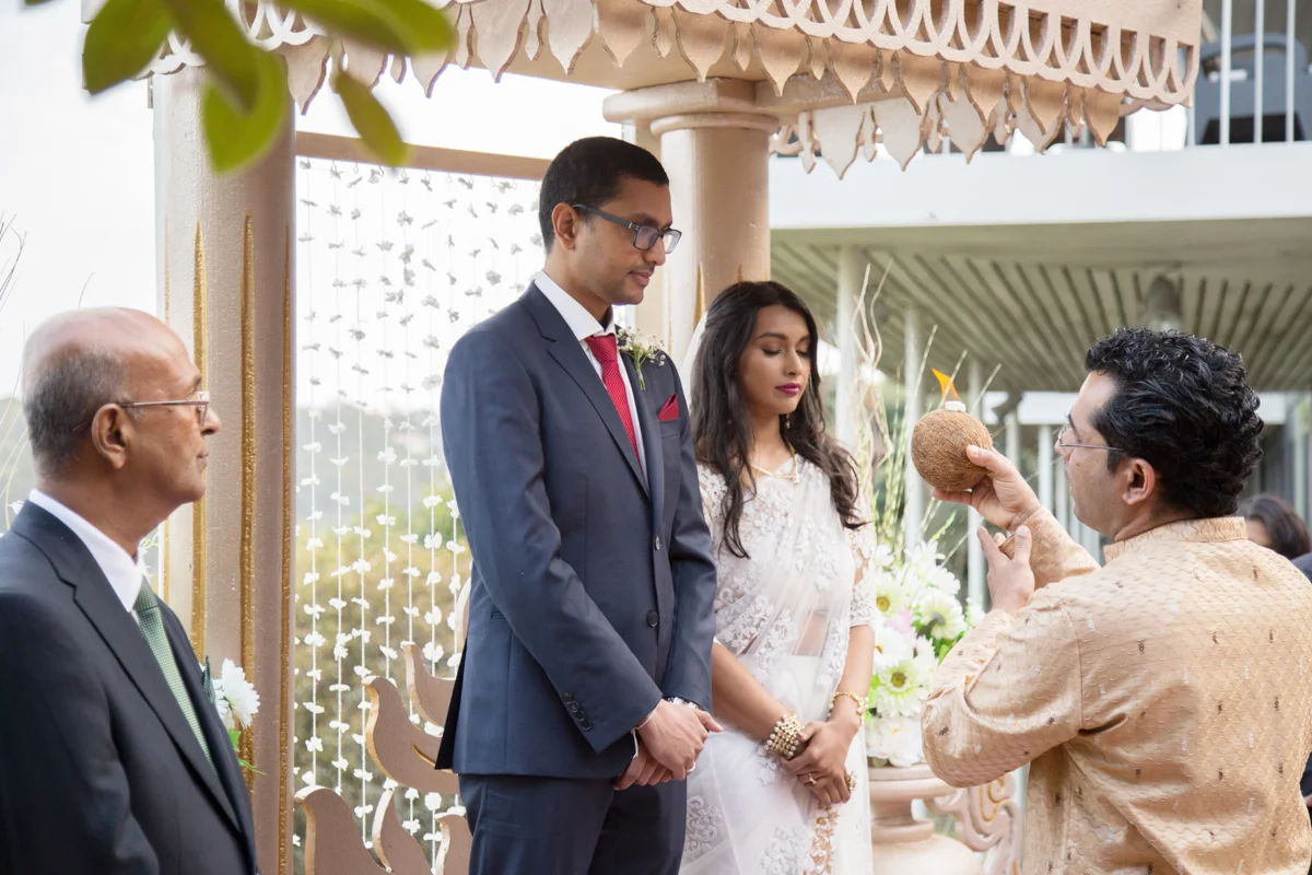 sri lankan wedding in sydney australia pundit holding candle during ceremony