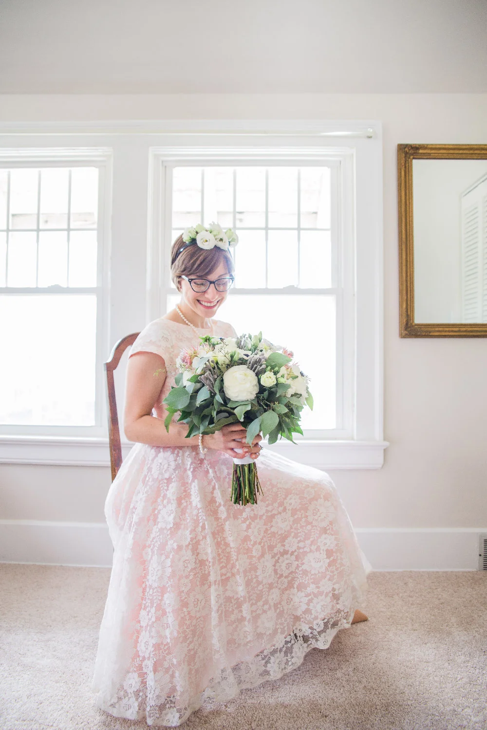 Bethany sitting in chair wearing pink lace wedding dress holding bouquet and wearing flower crown Cleveland Ohio Lea Marie Photography