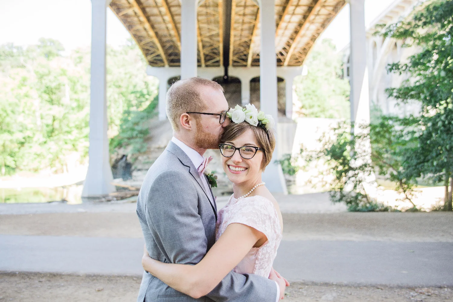Greg kissing bethany’s forehead under bridge for wedding photos Cleveland Ohio Lea Marie Photography