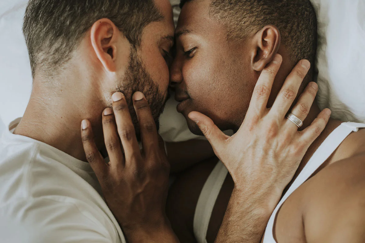 two married men embraced in bed