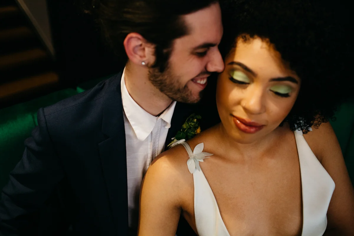 wes anderson inspired wedding styled shoot columbia south carolina couple on couch smiling