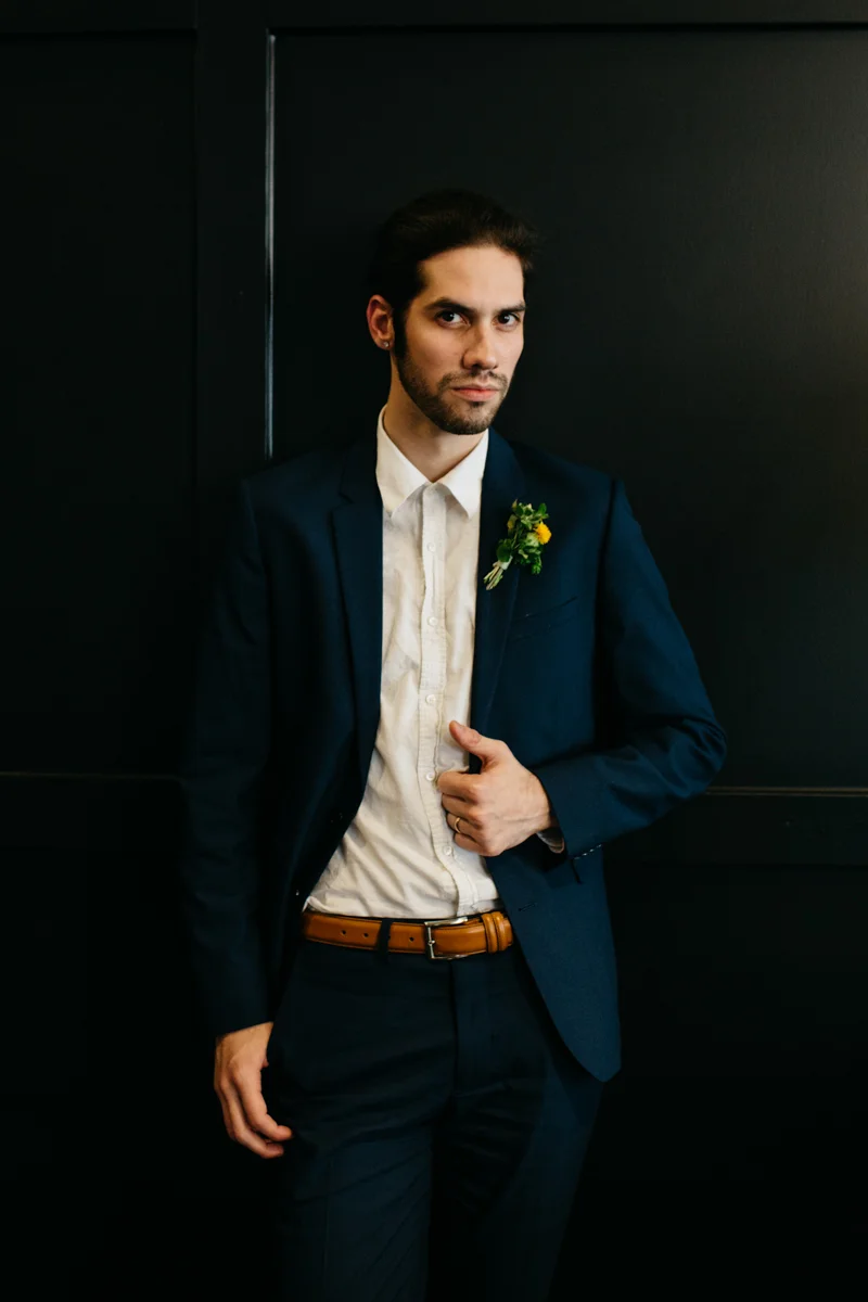 wes anderson inspired wedding styled shoot columbia south carolina groom posing with hand on jacket lapel