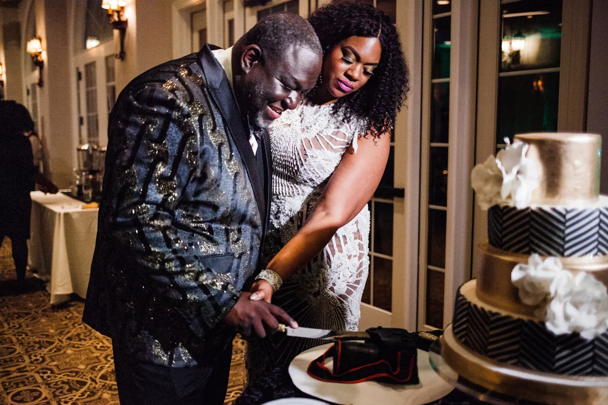 glam wedding river walk south carolina dana and tj cutting cake