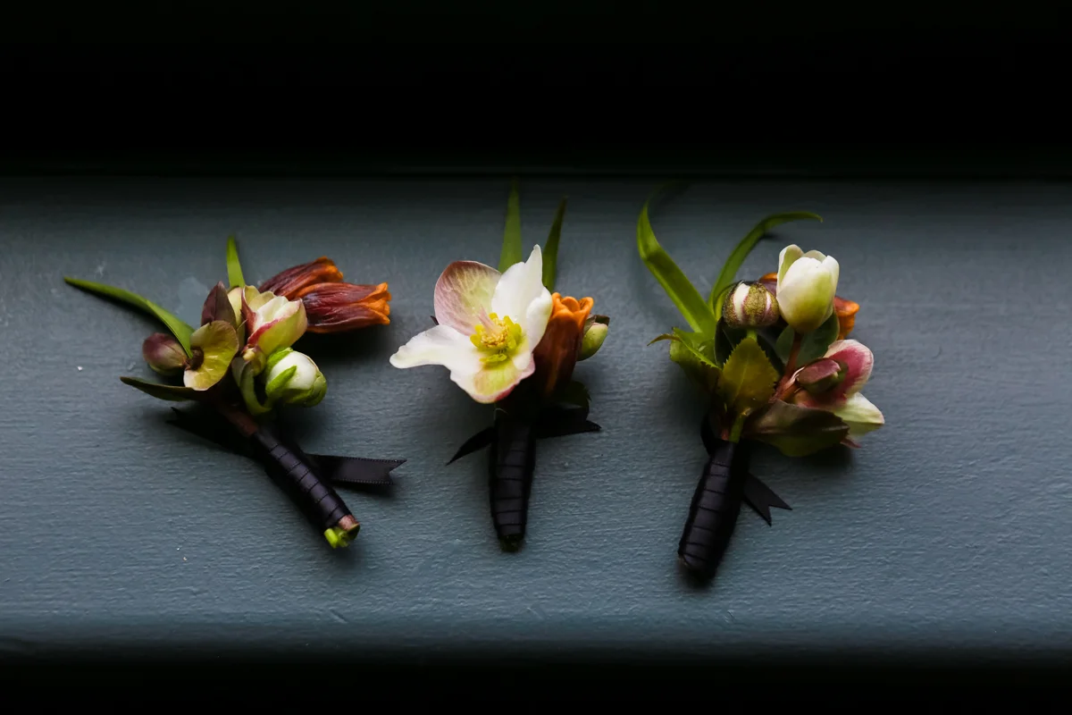 Modern traditional blended styled shoot new york three BOUTONNIEREs on table