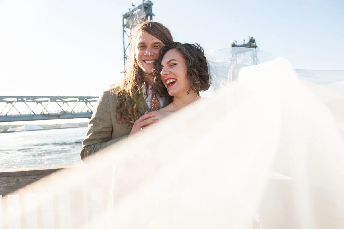 Newlywed couple posing together on the beach Leise Jones Photography Boston MA