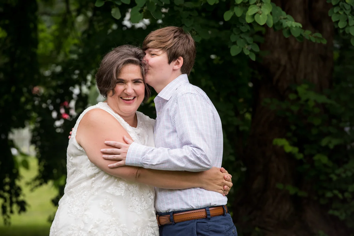 Newlywed couple holding each other surrounded by greenery Leise Jones Photography Boston MA