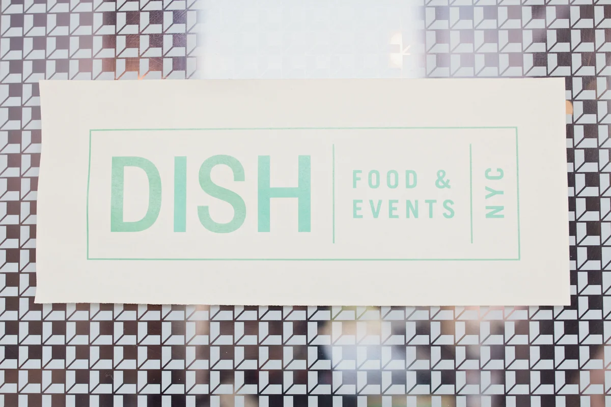 80s themed pride party brooklyn new york sign on window reading “dish food and events nyc”