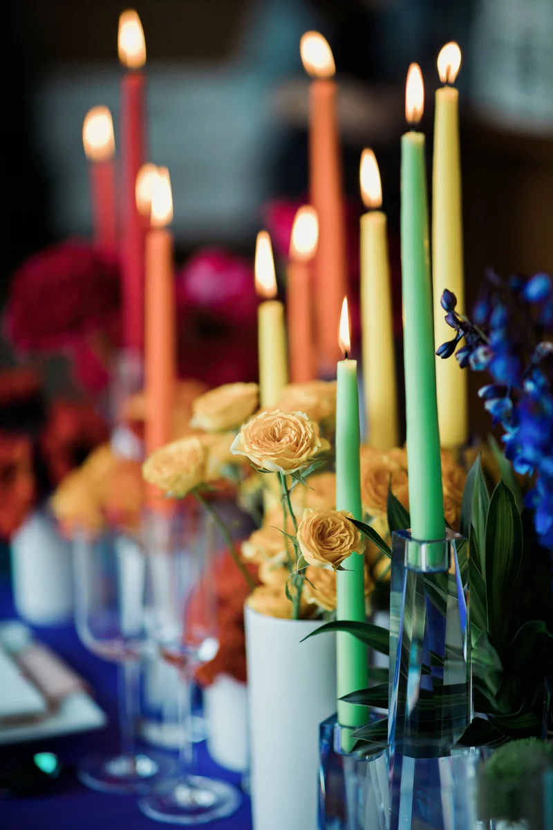 80s themed pride party brooklyn new york close up of green and yellow candles and flowers