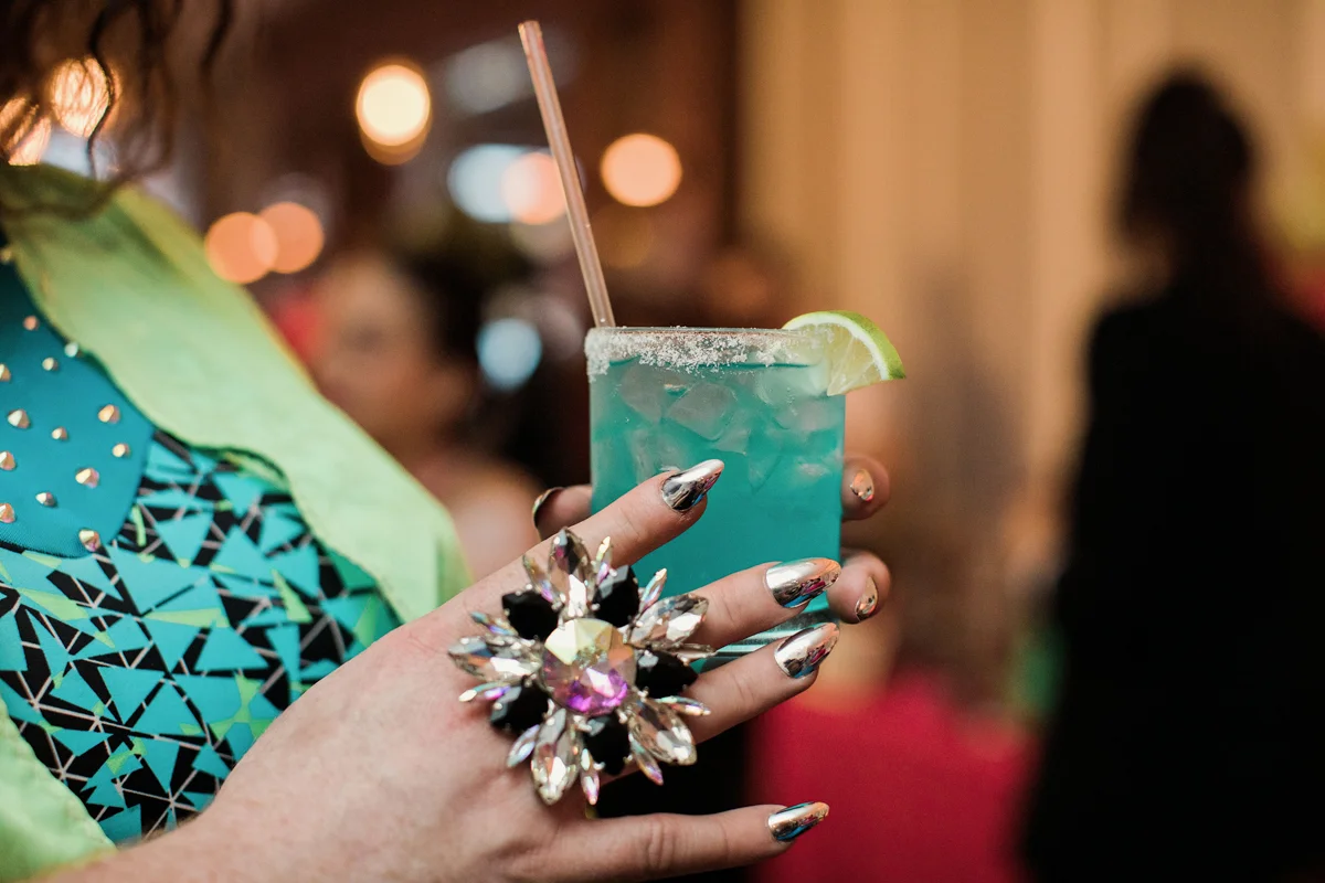 80s themed pride party brooklyn new york guest holding electric drink holding large chunky ring