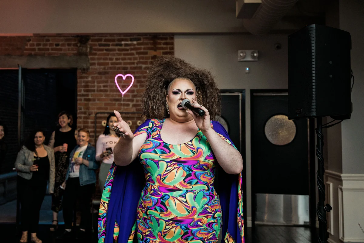 80s themed pride party brooklyn new york lauren ordair performing in colorful dress and cape