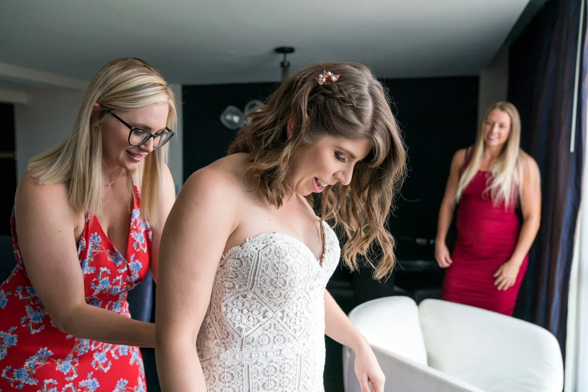 Brewery wedding washington D.C. bride having dress fastened