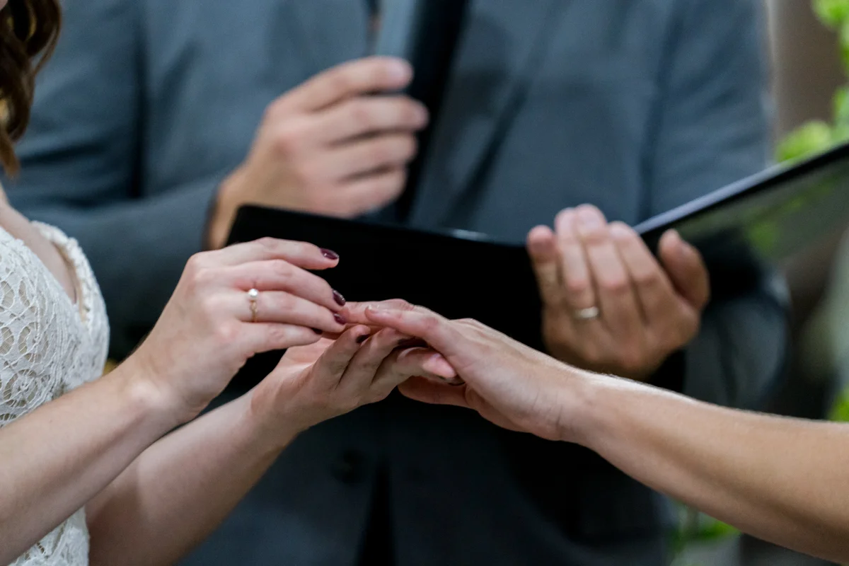 Brewery wedding washington D.C. brides exchanging rings during ceremony