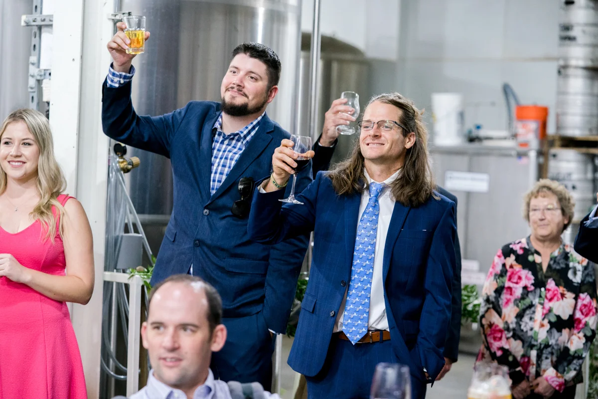 Brewery wedding washington D.C. guests lifting glasses in toast