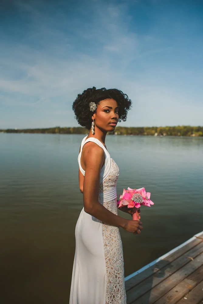 wedding inspiration the boathouse at sunday park midlothian virginia bride by river holding paper flower bouquet
