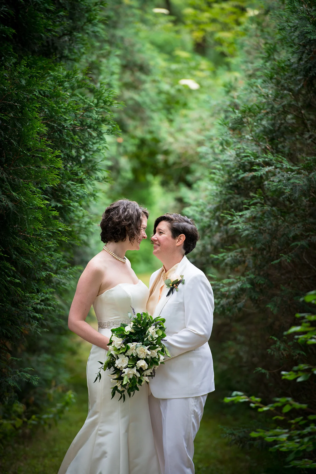 newlywed couple gazing in each others eyes after their wedding with woods behind them michelle schapiro photography