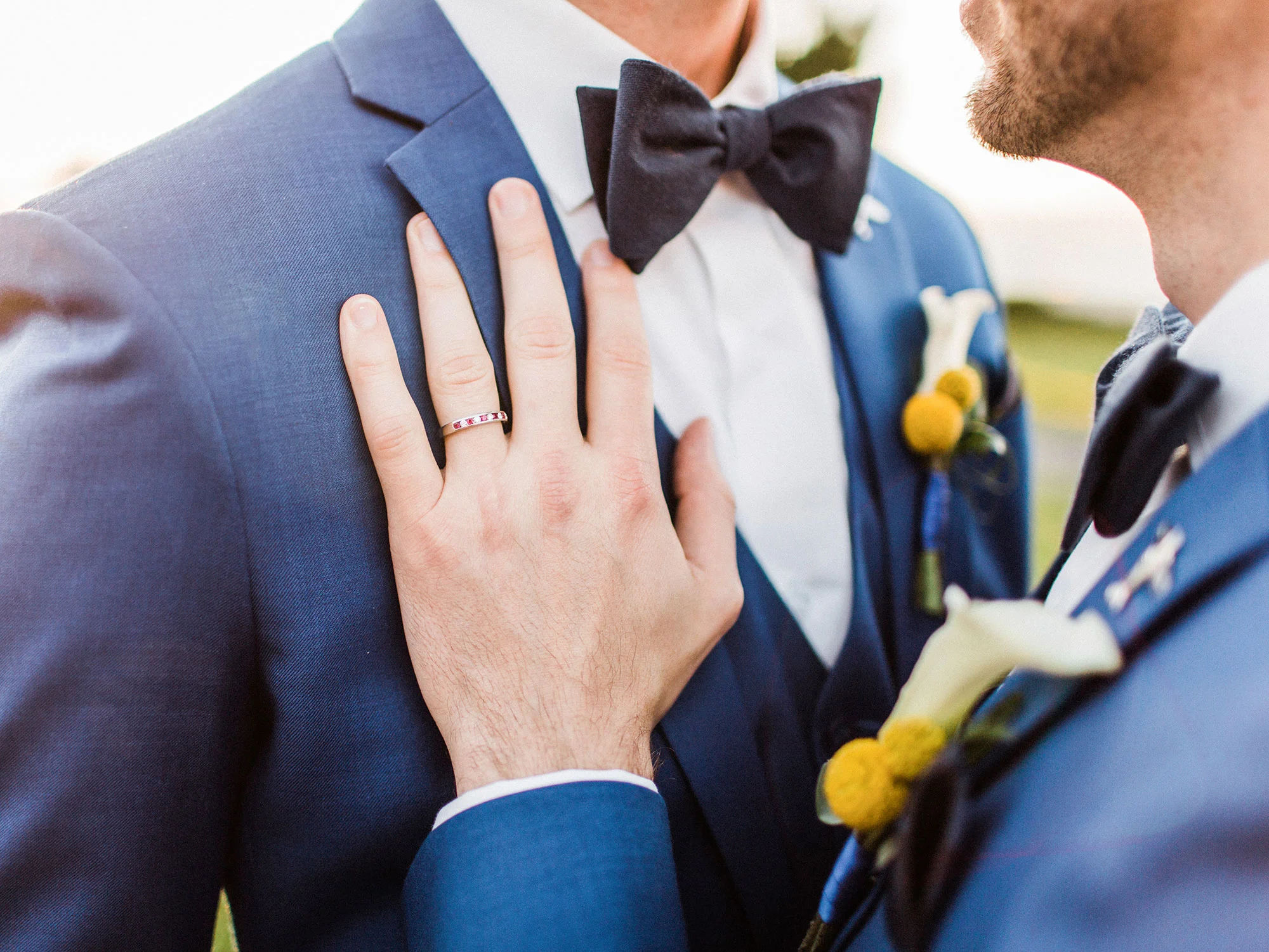 two grooms in matching suits embracing at their wedding Apollo Fotografie San Francisco